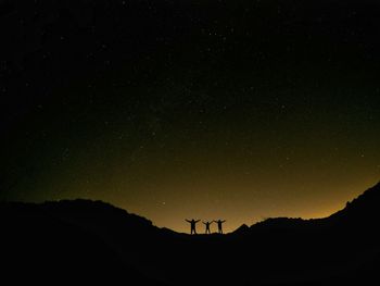 Low angle view of silhouette landscape against sky at night