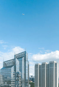 Low angle view of buildings against cloudy sky