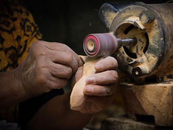 Close-up of man working at machine