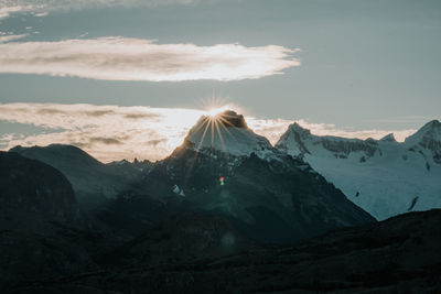 Scenic view of snowcapped mountains against sky during sunset