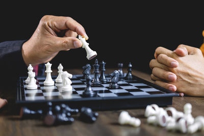 People playing chess on table