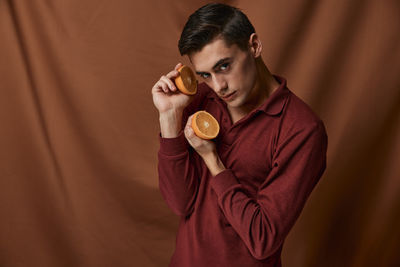 Portrait of young man holding ice cream