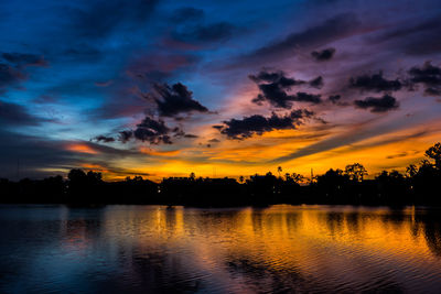 Scenic view of lake against orange sky