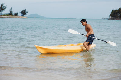 Man kayaking in sea