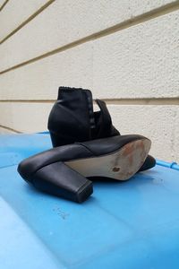 High angle view of black shoes on wall