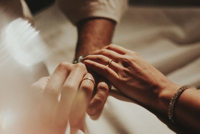 Midsection of couple hands