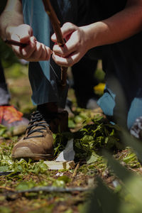 Midsection of man preparing food on field