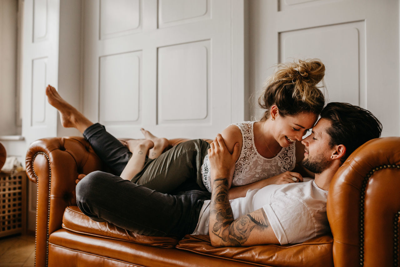 Affectionate couple on sofa at home