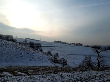 Scenic view of field against sky during winter