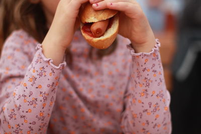 Midsection of woman holding pumpkin