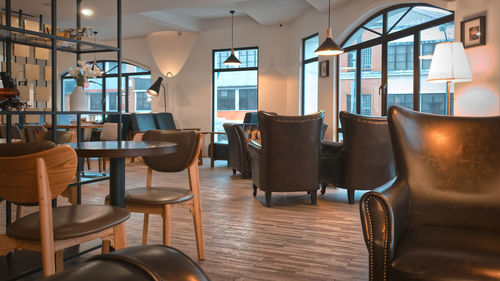 Empty chairs and tables in modern cafe