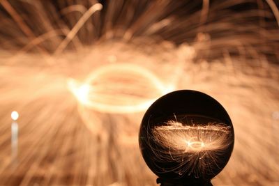 Crystal ball with reflection against wire wool