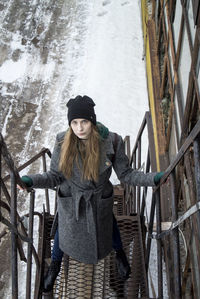 Portrait of young woman standing in winter