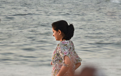 Full length of woman standing on beach