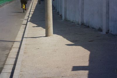 Shadow of person on road