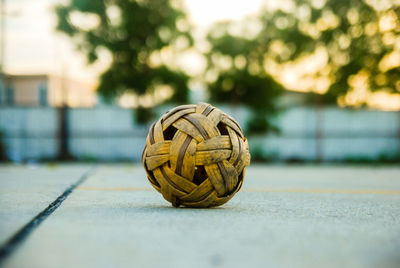 Close-up of wicker ball against sky