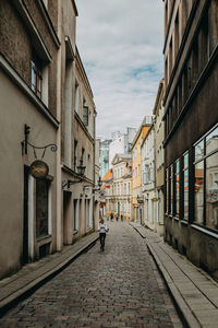 Street amidst buildings in city against sky