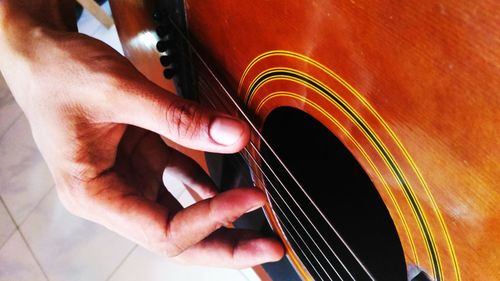 Cropped hands of person playing guitar