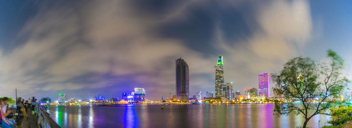 Panoramic view of illuminated buildings by city against sky