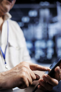 Midsection of woman using mobile phone