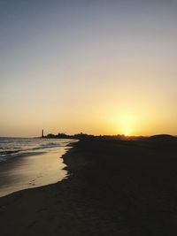 Scenic view of sea against clear sky during sunset