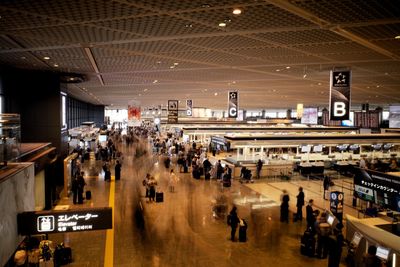 Group of people waiting for sale at airport