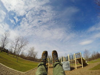 View of grassy field against cloudy sky