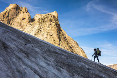 Mountaineer climbs glacier on approach to mount asgard.