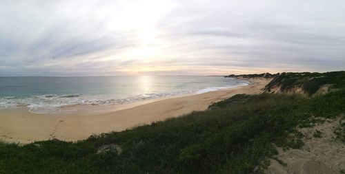 Scenic view of beach against sky during sunset