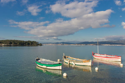 Boat moored on sea against sky