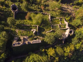 High angle view of old house amidst trees and buildings