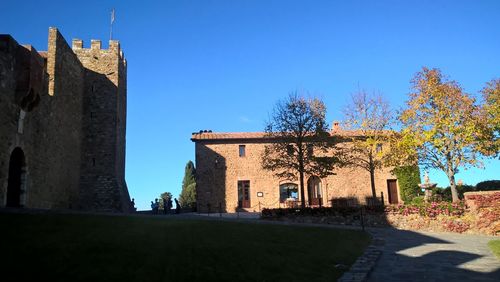 Low angle view of historic building against clear blue sky