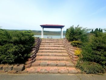 Stairs leading to built structure against clear sky