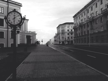 Street amidst buildings in city against sky