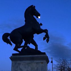 Low angle view of statue against blue sky