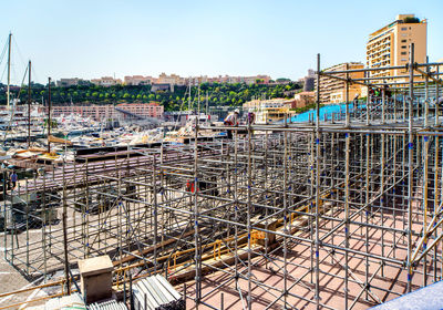 Construction site in city against clear sky