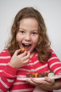 Portrait of smiling girl eating food