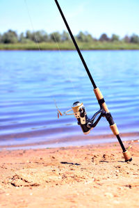 Close-up of fishing rod in lake