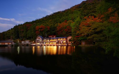 Scenic view of lake by trees against sky