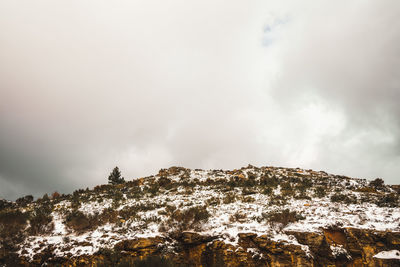 Low angle view of snowcapped mountain against sky