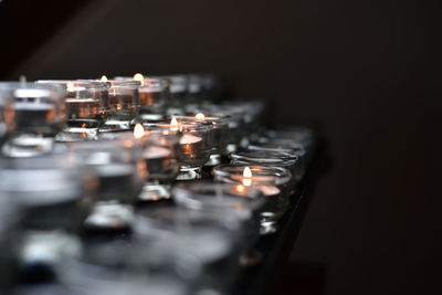 Close-up of illuminated candles on black background