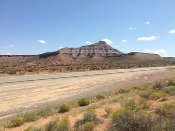 Scenic view of landscape against blue sky