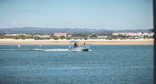 Man on sea against sky