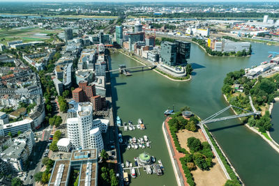 High angle view of bridge over river amidst buildings in city