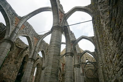 Low angle view of old ruin against sky