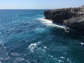 Scenic view of sea against clear blue sky