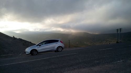 View of road against cloudy sky