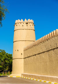 Low angle view of fort against clear blue sky