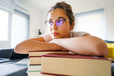 Portrait of woman sitting on book