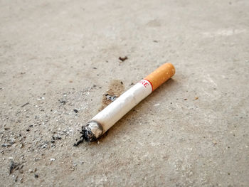 High angle view of cigarette on street